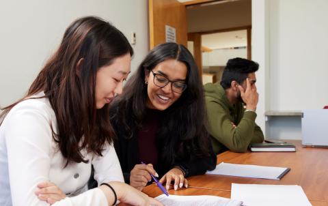 two students looking at a document